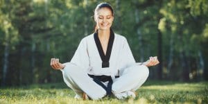 Martial Arts Lessons for Adults in Lemoyne PA - Happy Woman Meditated Sitting Background